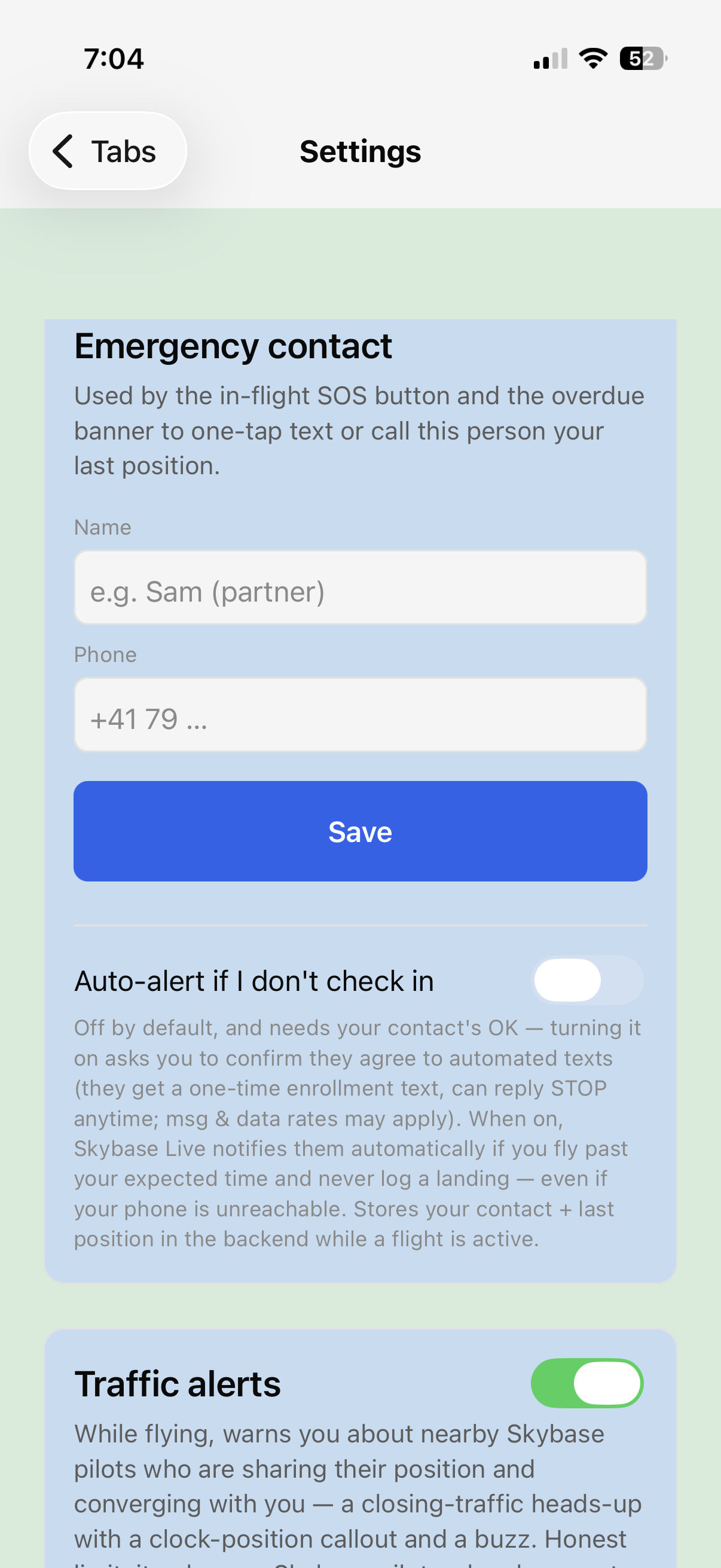 Skybase Settings — Emergency contact card with the SMS disclosure text under the auto-alert toggle